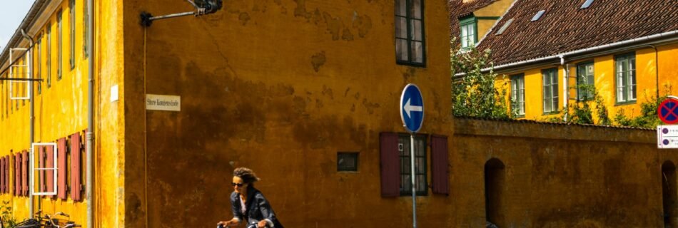 A person riding a bike down a street