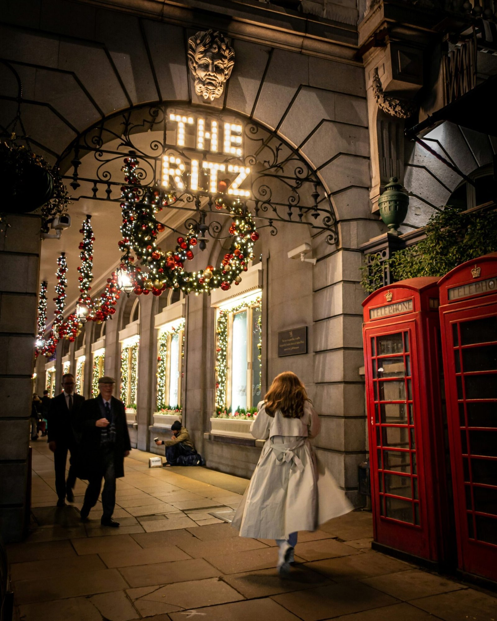 a little girl in a white dress is walking down the street