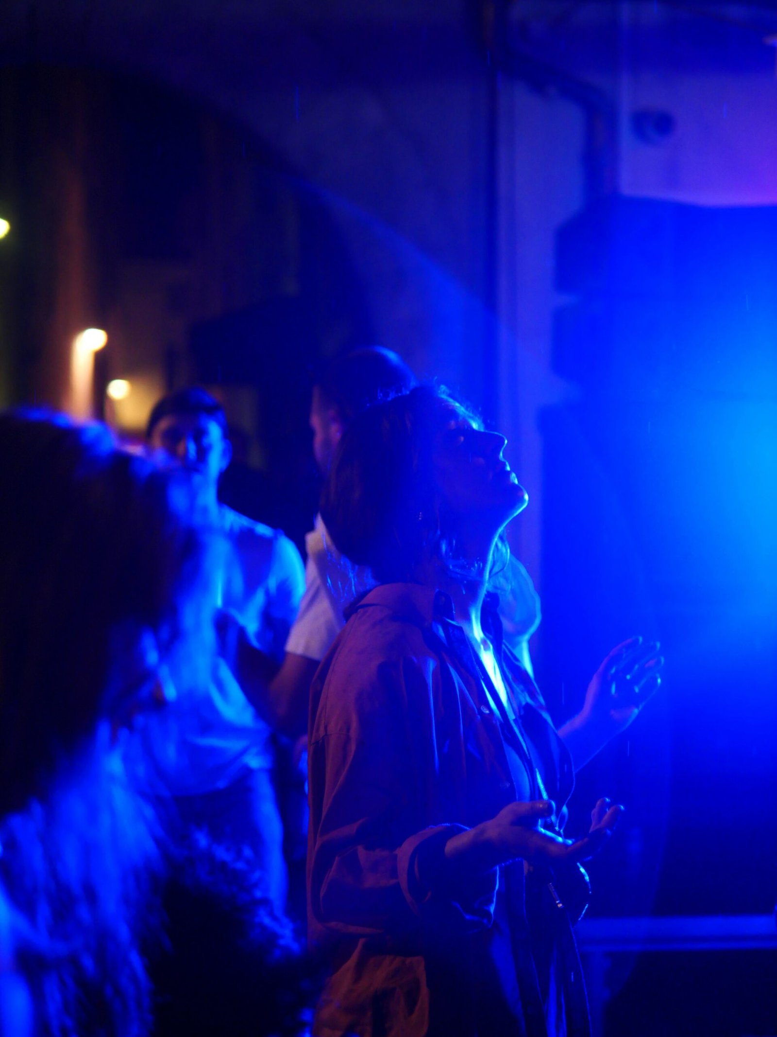 a man standing in front of a blue light