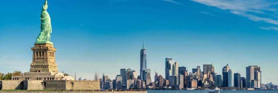 city skyline across body of water during daytime