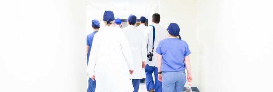 group of doctors walking on hospital hallway