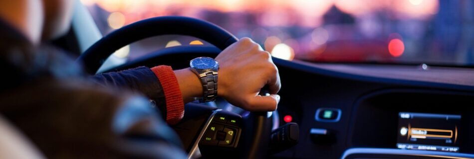 man driving a car wearing wrist watch