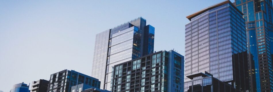 white and blue glass walled high rise building